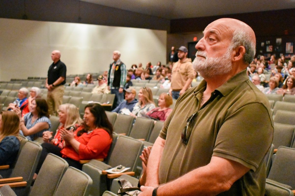 Veterans in audience standing